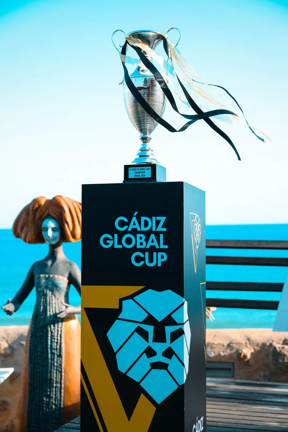 Trofeo de la Cádiz Global Cup junto al logo del torneo